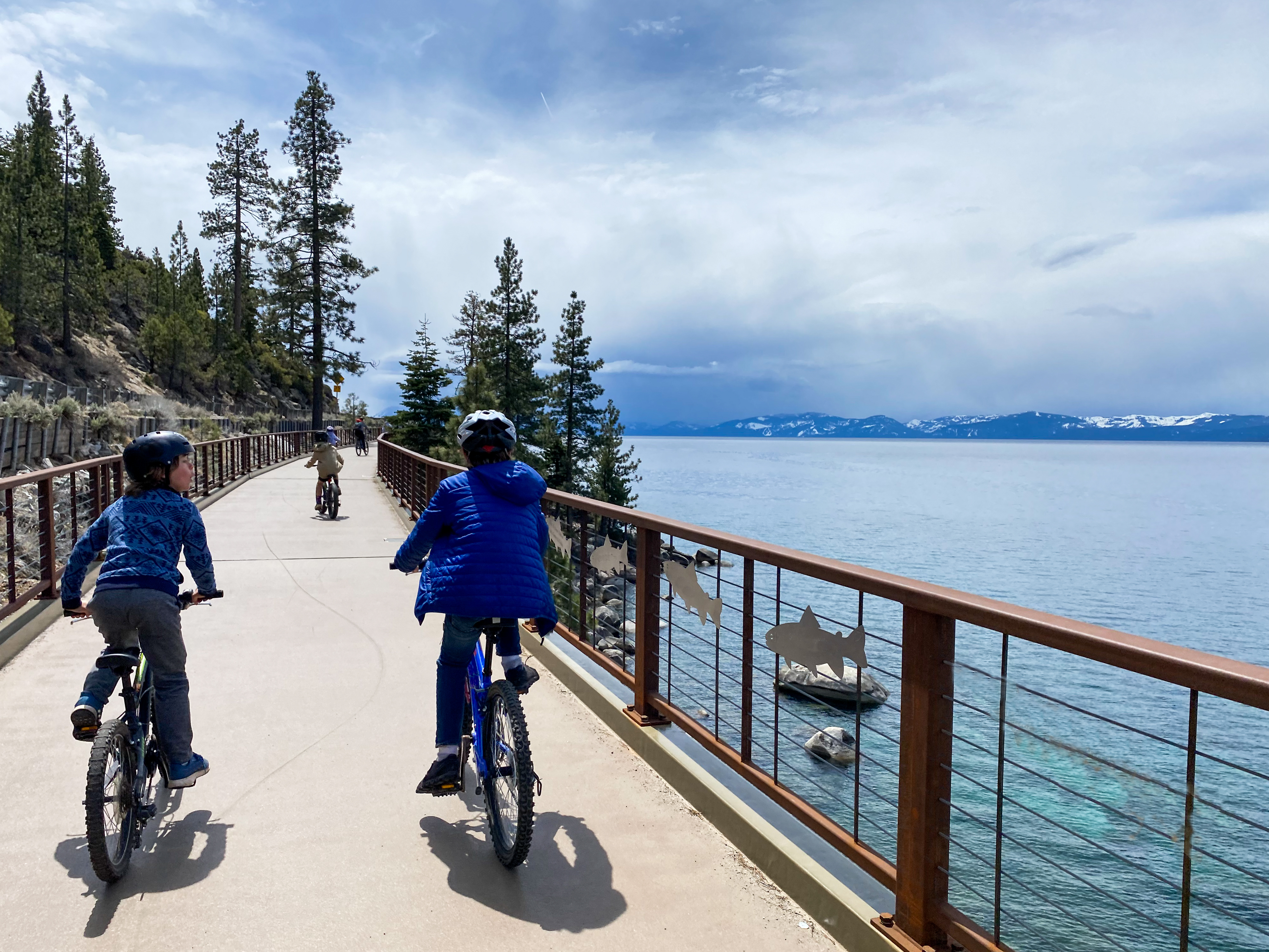 Adult and youth biking along the East Lake Tahoe bike path